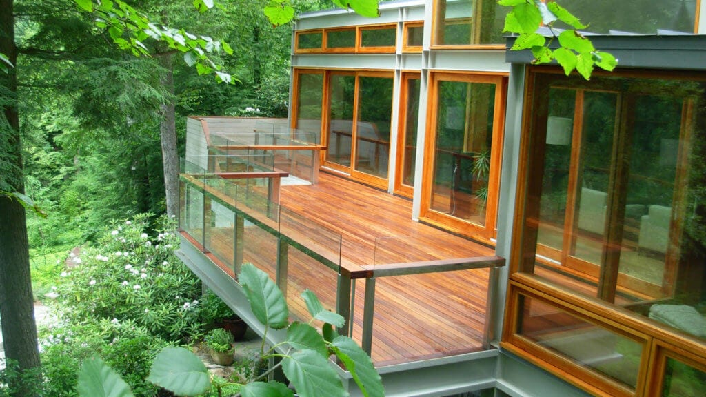 Stained IPE Deck with glass Railings in Pound Ridge, NY