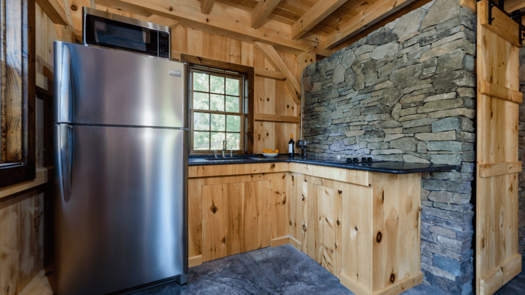 post beam style timber frame pool house northern white pine ashlar stone barn door hardware cement slab floor radiant heat kitchen honed granite counter katonah westchester