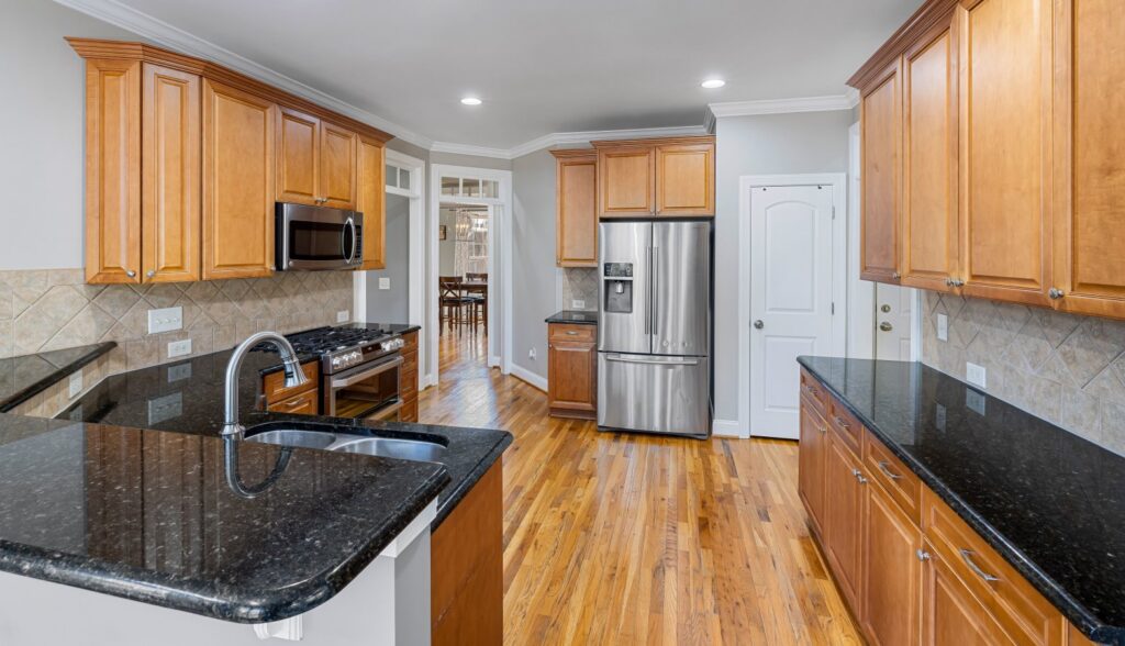Spacious kitchen blending modern stainless steel appliances with wooden cabinets reflecting historic charm