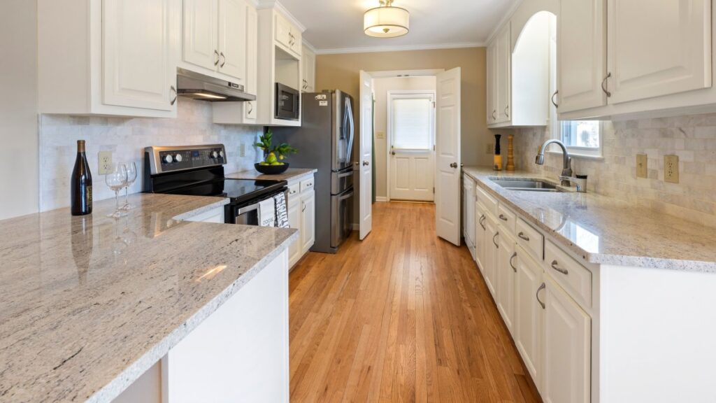 Elegant white kitchen with classic cabinetry and modern appliances blending period style with updated features