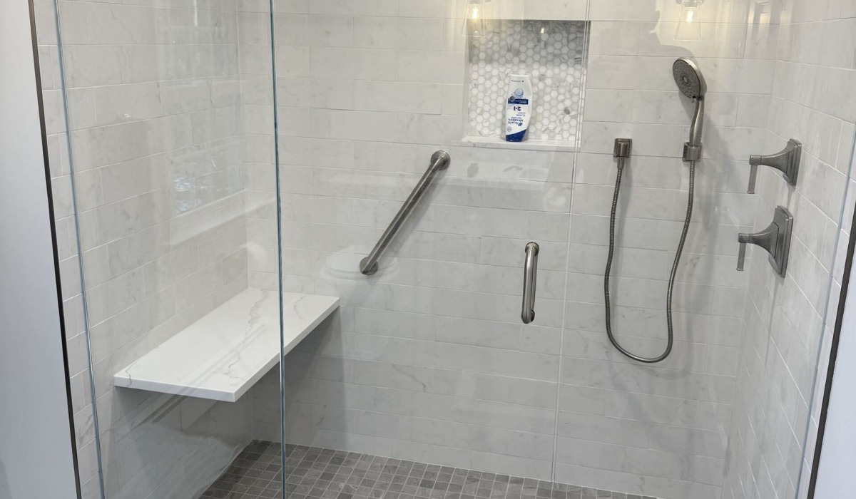 Glass shower with a marble bench